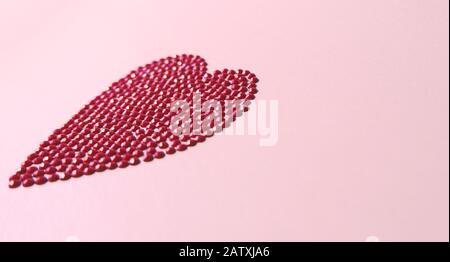 Big red love heart shiny puzzle round crystal circles shape concept on pink background. Flat lay side view, copy space valentine`s day. Stock Photo